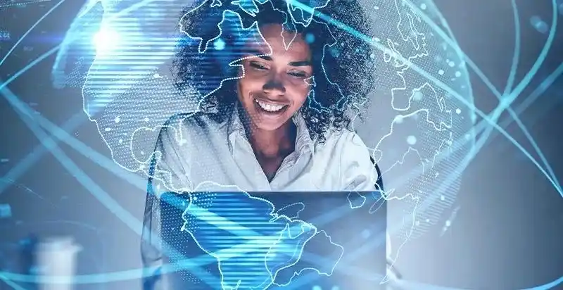 Best Online Digital Marketing Course for Beginners Smiling person using laptop surrounded by holographic world map and digital network connections, representing global digital marketing